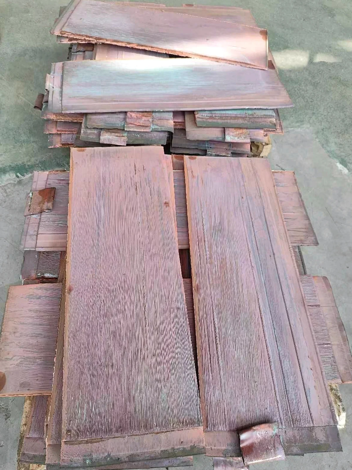 Metal strip and wire samples held for inspection
